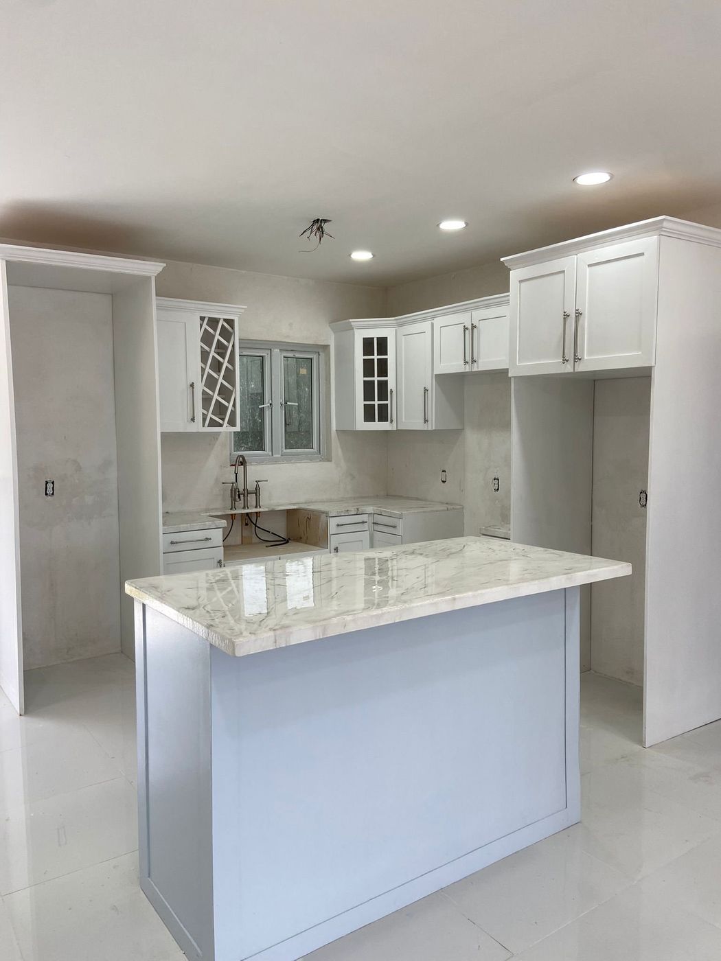 Luxury kitchen renovation with custom cabinetry and marble island